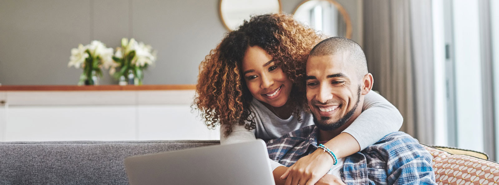 Couple looking at a laptop together.