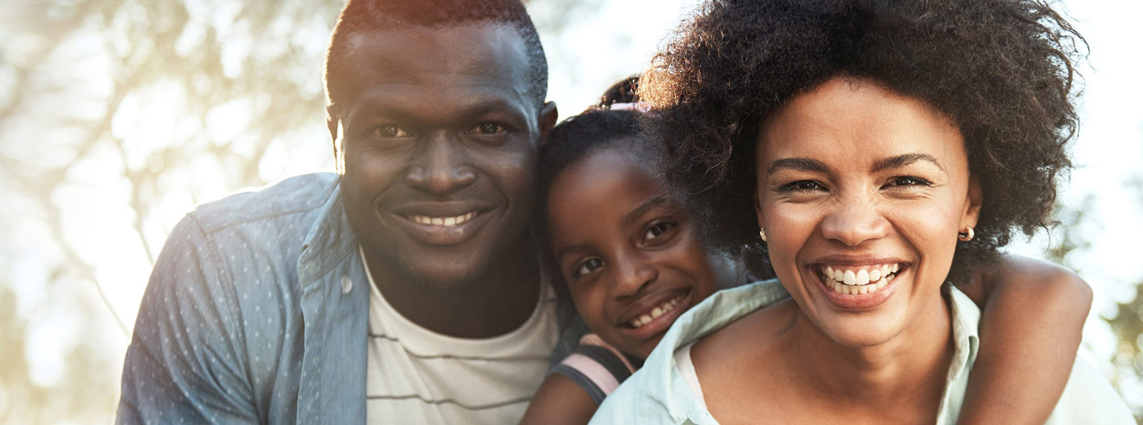 Family smiling outdoors.