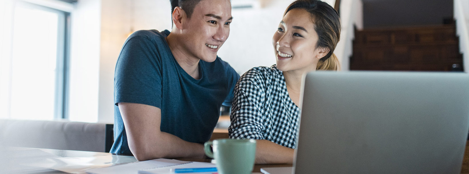 Couple sitting at a laptop.
