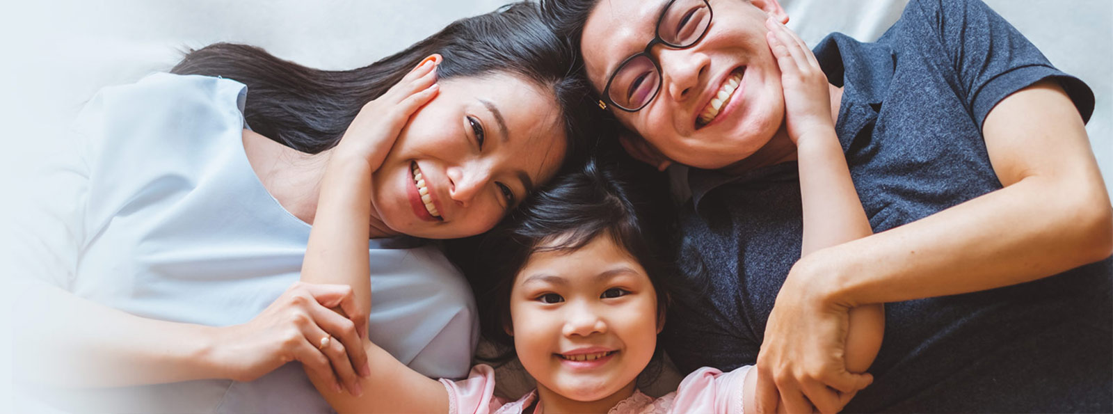 Family cuddling and smiling.