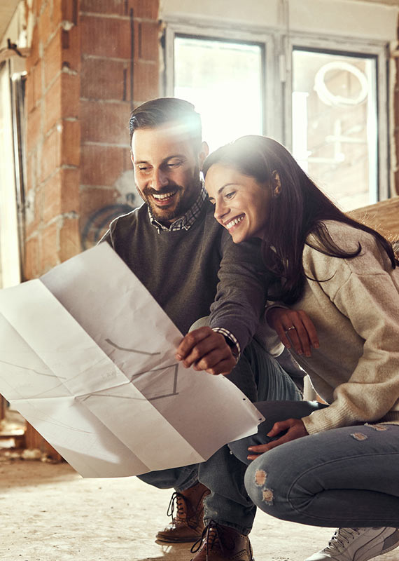 Couple looking at home improvement plans.